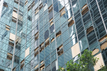 Shattered and boarded up windows are seen on the side of the Wells Fargo Plaza building in Houston, Texas