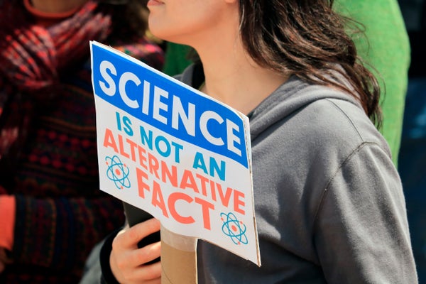 Unidentified woman holds a protest sign saying "Science is not an Alternative Fact" at 2017 March for Science rally in Lafayette Indiana