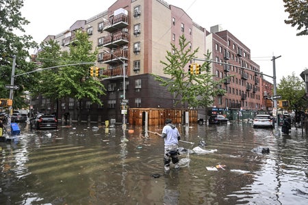 Man managing water during a flash flood.